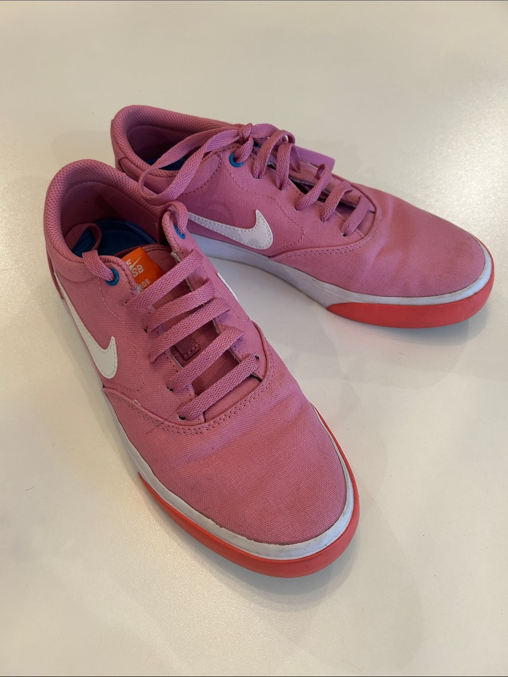 Nike Pink Canvas Sneakers with White Swoosh and Coral Sole Trim